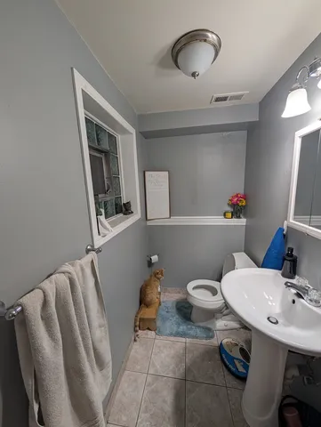 a bathroom with a sink mirror and toilet