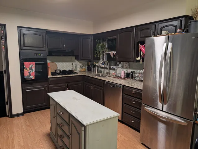 a kitchen with stainless steel appliances a refrigerator and a stove