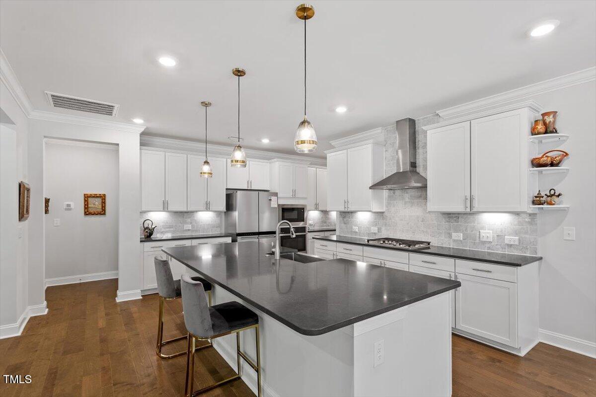 131 English Violet Lane Raleigh, NC 27610 - Photo 12 of 45 a kitchen with kitchen island a sink table and chairs
