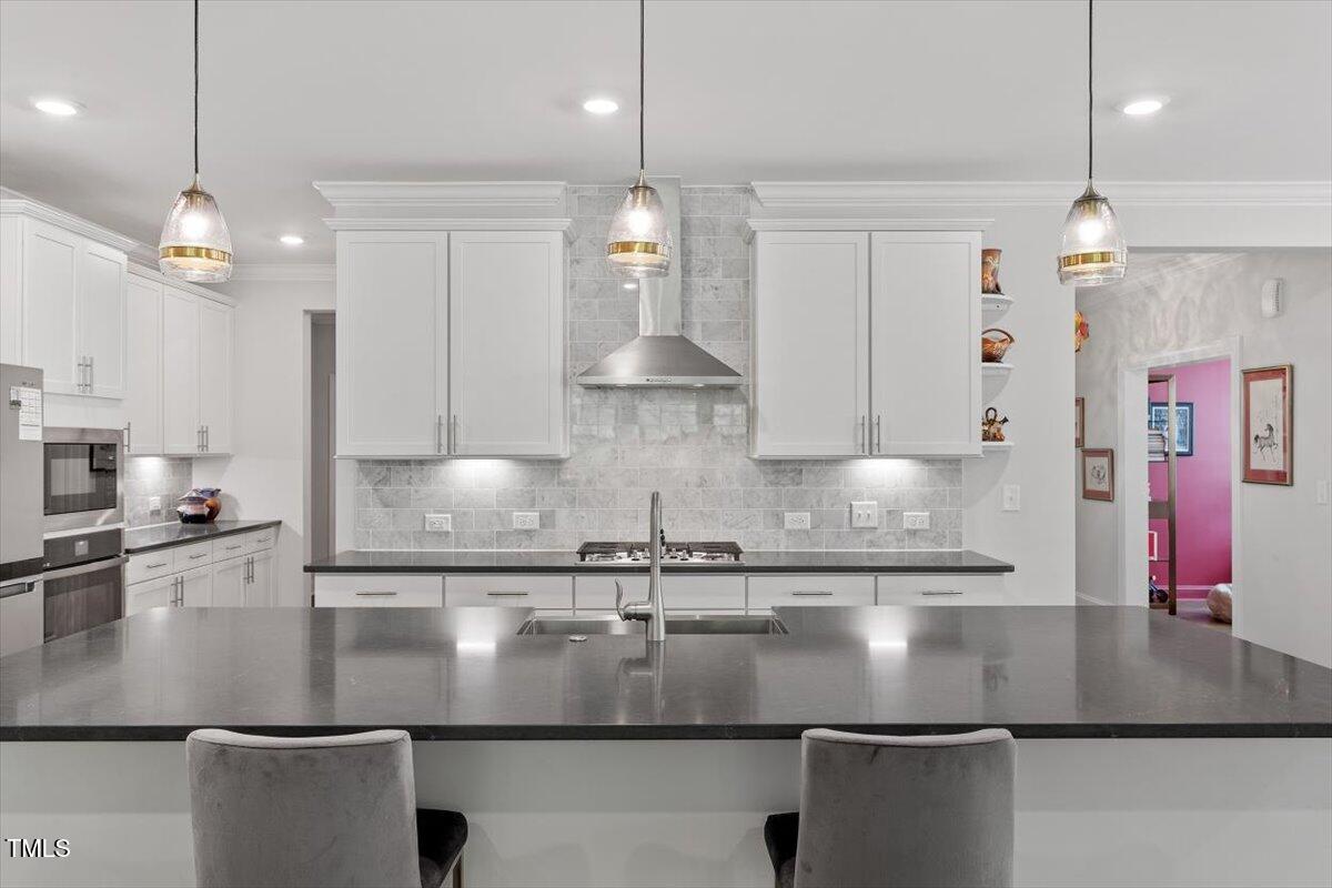 131 English Violet Lane Raleigh, NC 27610 - Photo 13 of 45 a view of a kitchen with stainless steel appliances granite countertop a sink a stove and a granite counter tops