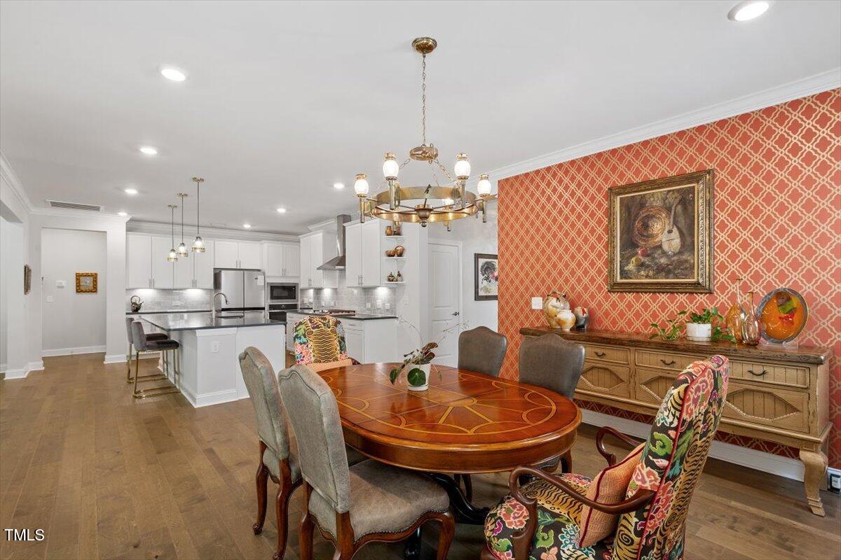 131 English Violet Lane Raleigh, NC 27610 - Photo 18 of 45 a view of a dining room with furniture and wooden floor