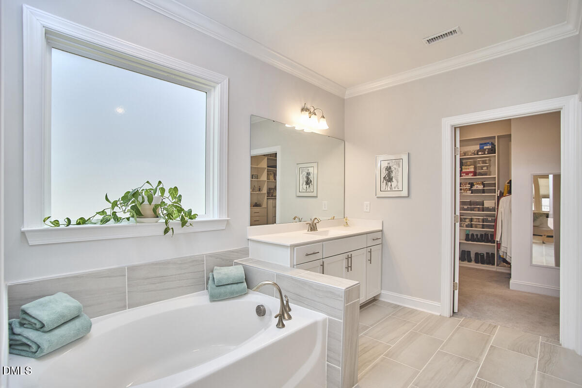 131 English Violet Lane Raleigh, NC 27610 - Photo 21 of 45 a bathroom with a bathtub sink and mirror