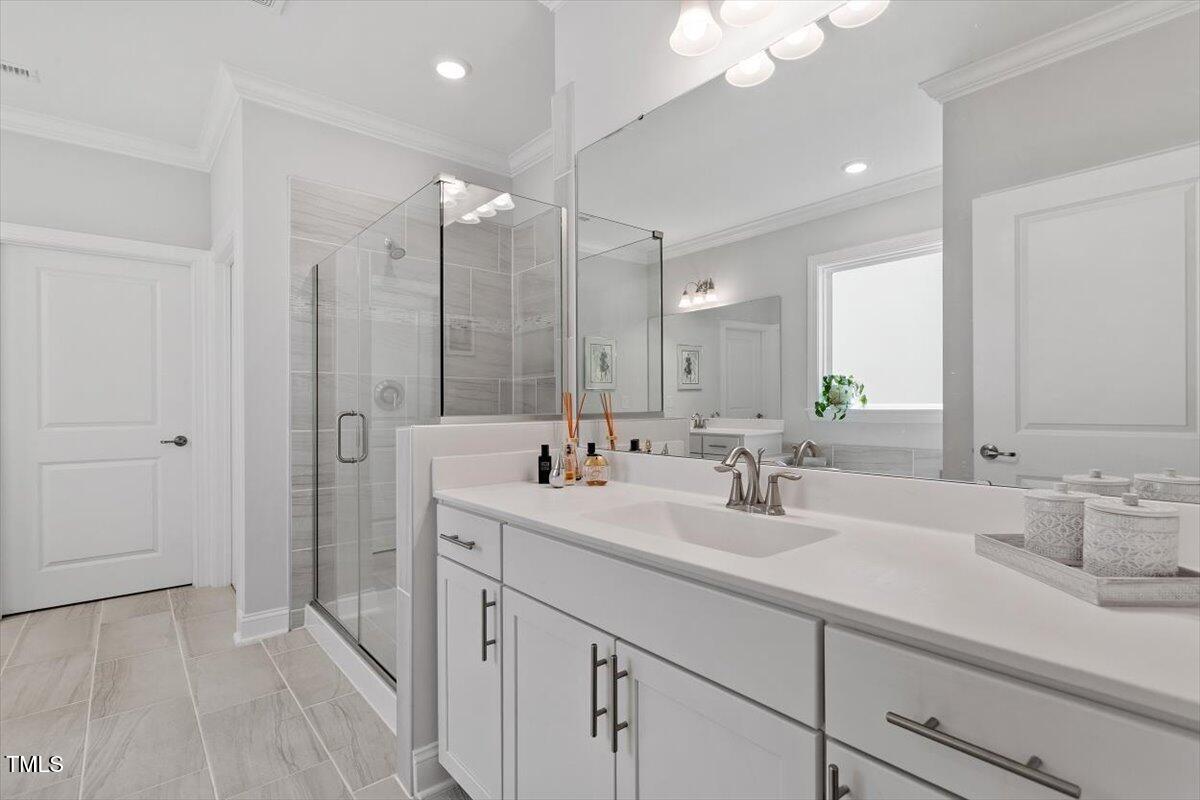 131 English Violet Lane Raleigh, NC 27610 - Photo 24 of 45 a bathroom with double sink and a mirror