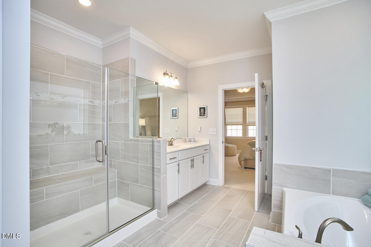 131 English Violet Lane Raleigh, NC 27610 - Photo 25 of 45 a bathroom with a granite countertop shower a mirror and a sink
