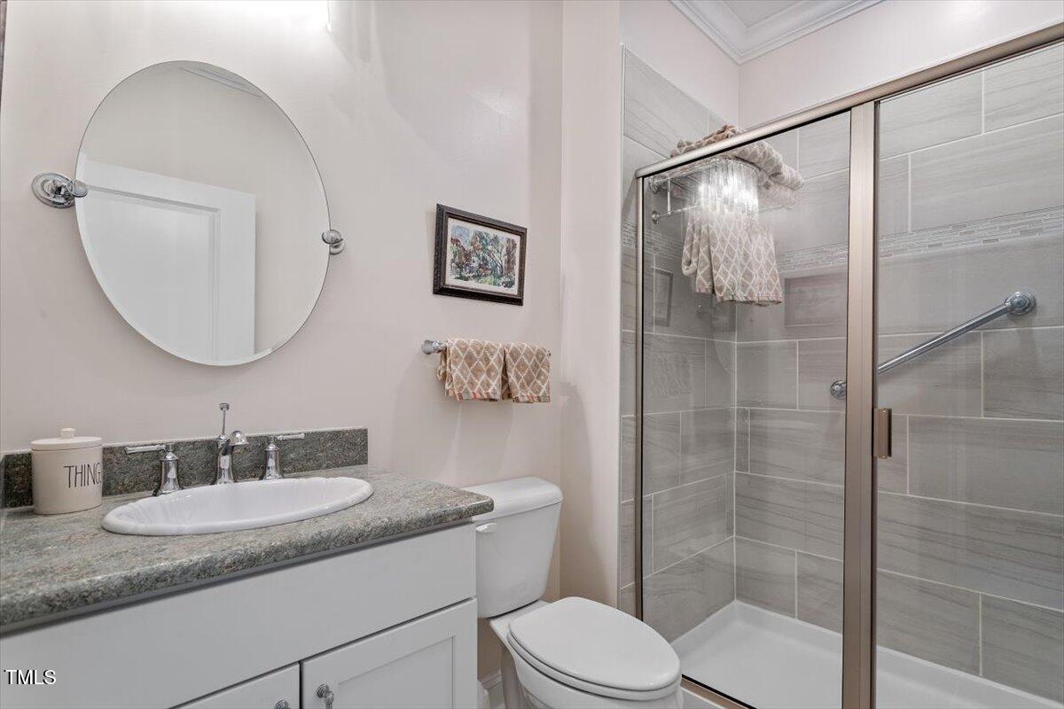131 English Violet Lane Raleigh, NC 27610 - Photo 27 of 45 a bathroom with a granite countertop sink toilet and shower