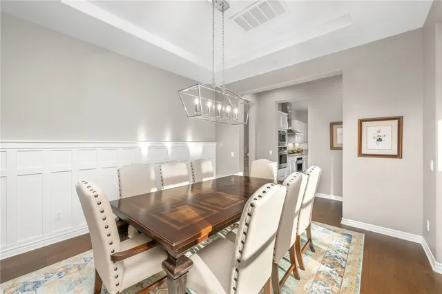 a living room with couches and a ceiling fan