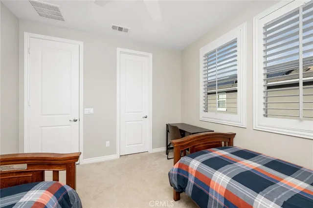 a bedroom with bed and a window