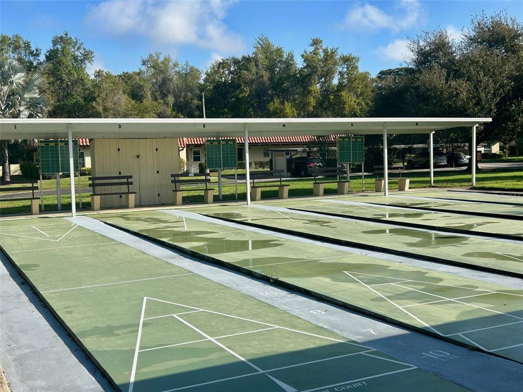 1701 Pinehurst Road, Unit 18C Dunedin, FL 34698 - Photo 16 of 17 a view of a tennis ground with large trees