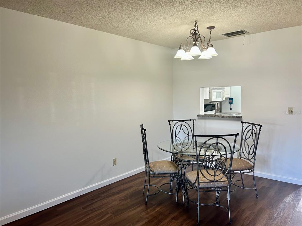 1701 Pinehurst Road, Unit 18C Dunedin, FL 34698 - Photo 5 of 17 a view of a dining room with furniture and chandelier