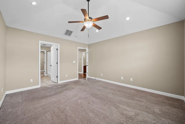 an empty room and a ceiling fan in a room