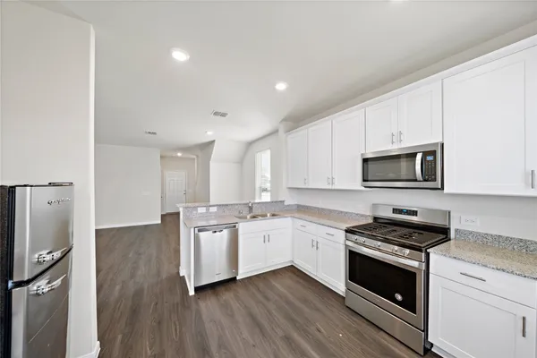 a kitchen with stainless steel appliances a white stove top oven and sink