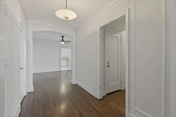 a view of a room with wooden floor and a window