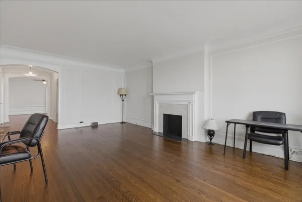 a view of empty room with furniture and wooden floor