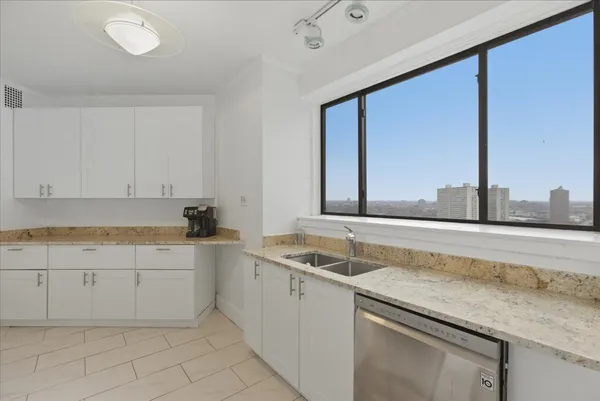 a kitchen with sink and cabinets