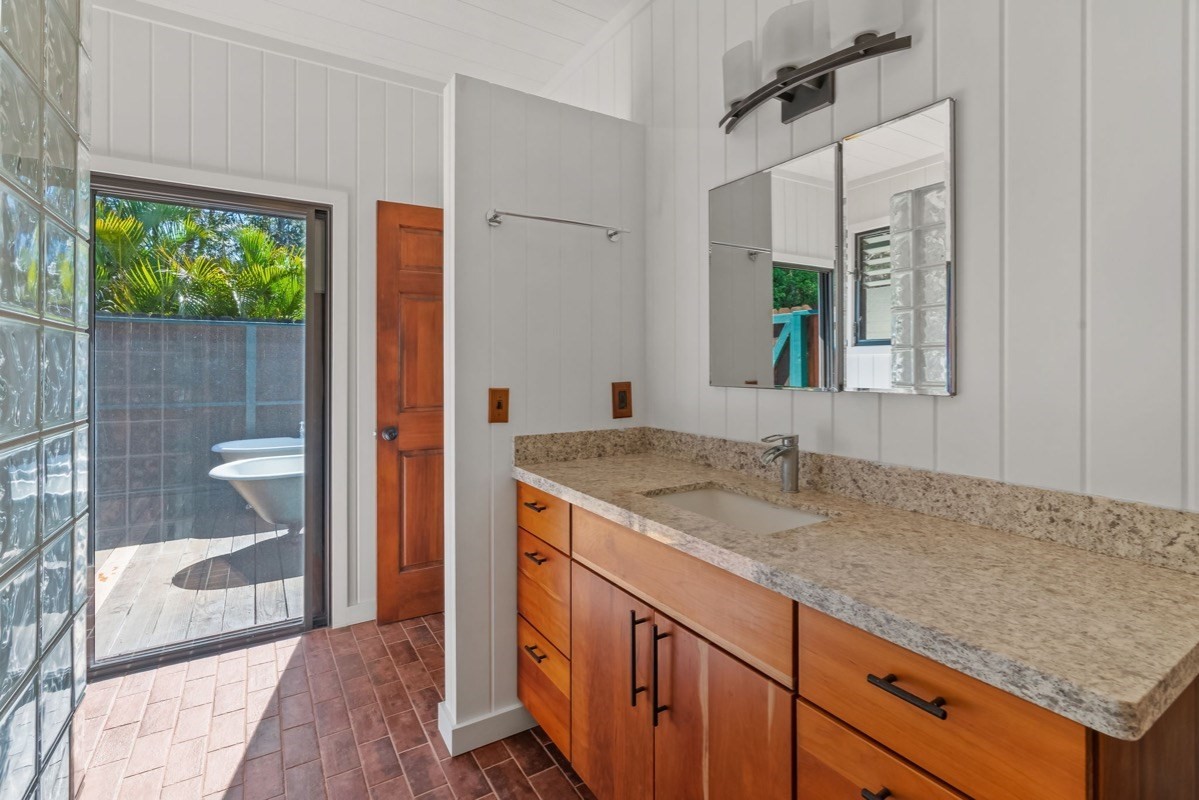 1613 Puu Road, Unit B Kalaheo, HI 96741 - Photo 17 of 27 a bathroom with a granite countertop sink and a mirror