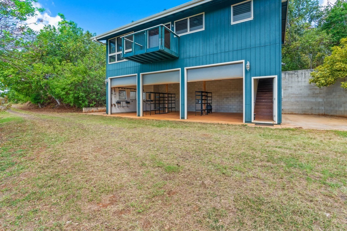 1613 Puu Road, Unit B Kalaheo, HI 96741 - Photo 22 of 27 front view of a house with a yard and an trees