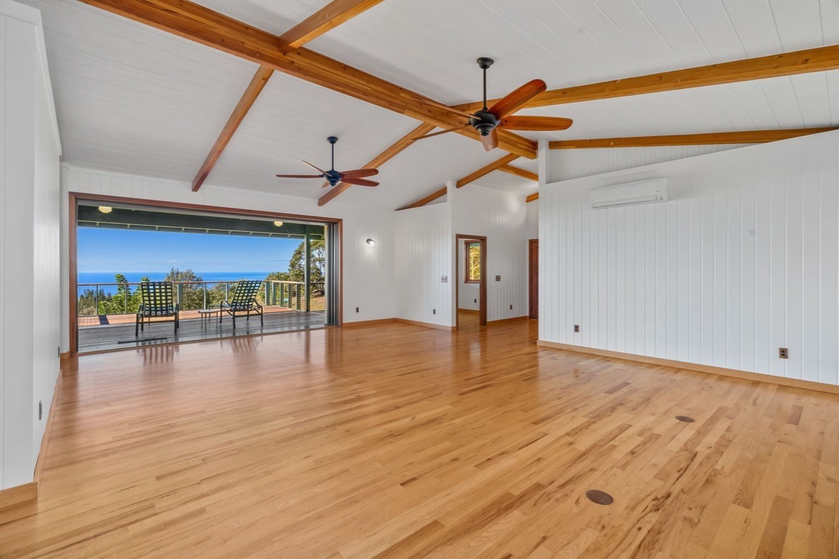 1613 Puu Road, Unit B Kalaheo, HI 96741 - Photo 8 of 27 a view of a room with wooden floor and windows