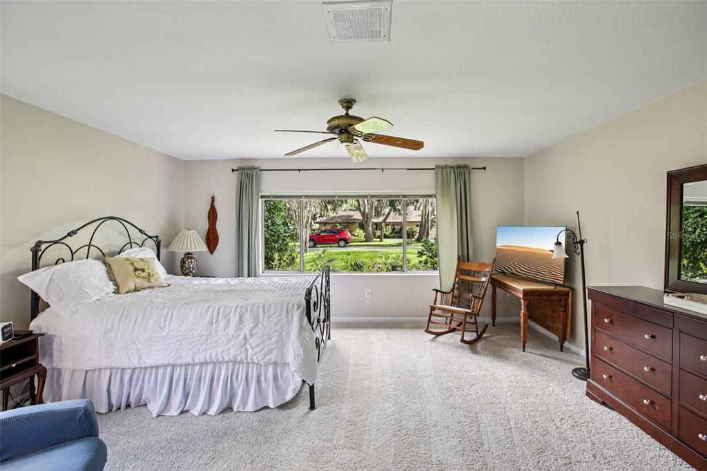 19254 Blount Road Lutz, FL 33558 - Photo 20 of 34 a bedroom with a bed and a chandelier