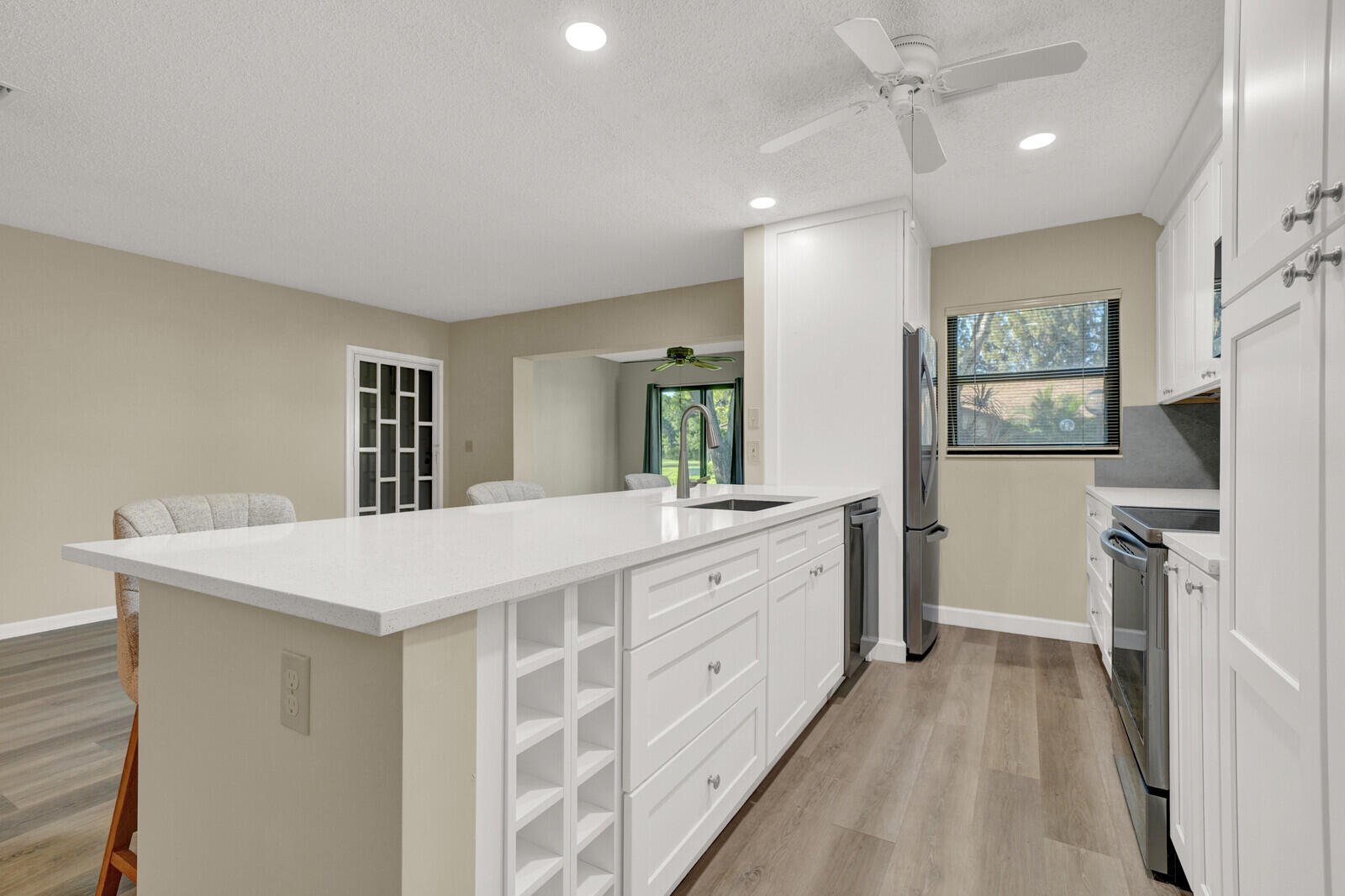 5270 Nesting Way, Unit C Delray Beach, FL 33484 - Photo 12 of 38 a large white kitchen with cabinets