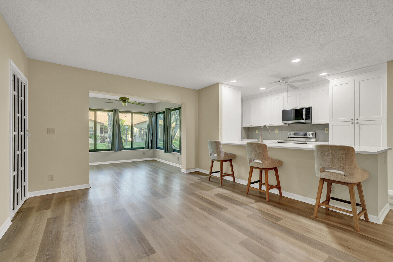 5270 Nesting Way, Unit C Delray Beach, FL 33484 - Photo 15 of 38 a view of kitchen with furniture and wooden floor