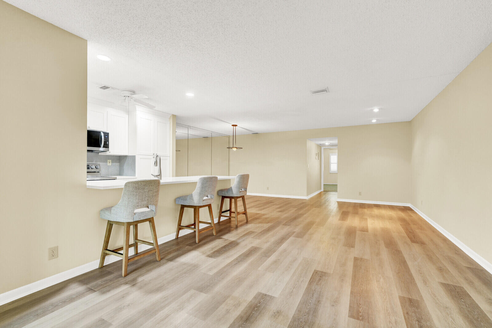 5270 Nesting Way, Unit C Delray Beach, FL 33484 - Photo 17 of 38 a view of a kitchen with dining room and wooden floor