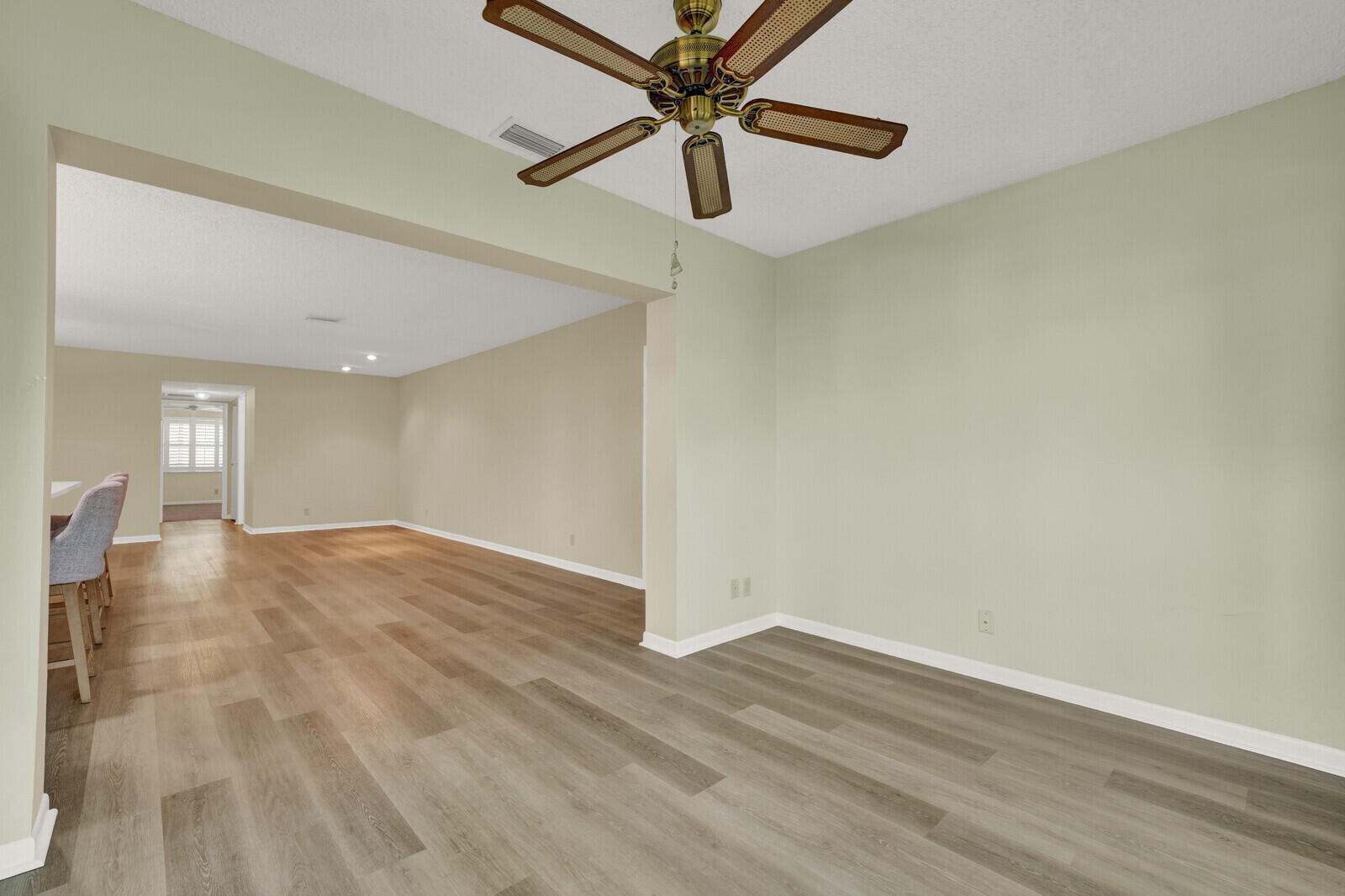 5270 Nesting Way, Unit C Delray Beach, FL 33484 - Photo 18 of 38 a view of a livingroom with a ceiling fan and hardwood floor