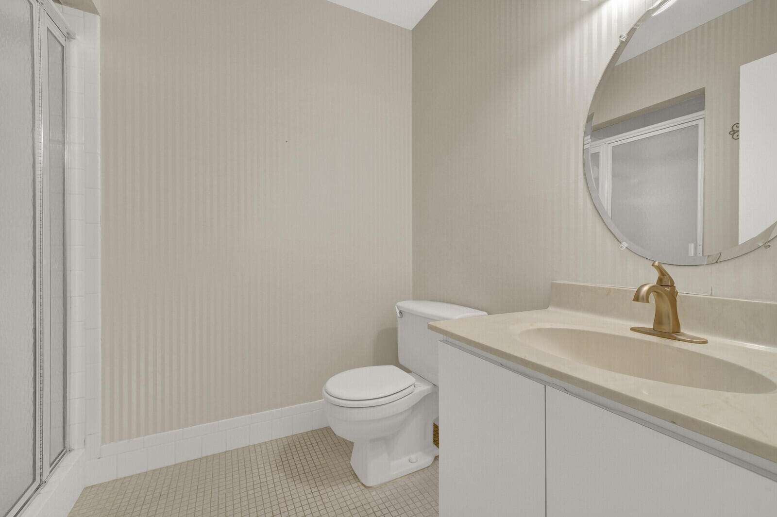 5270 Nesting Way, Unit C Delray Beach, FL 33484 - Photo 20 of 38 a bathroom with a toilet a sink and mirror