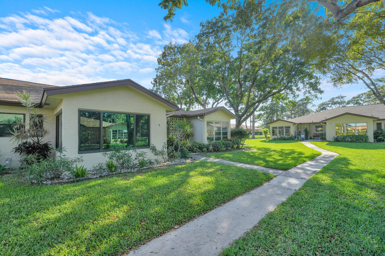 5270 Nesting Way, Unit C Delray Beach, FL 33484 - Photo 2 of 38 a view of a house with a big yard and potted plants