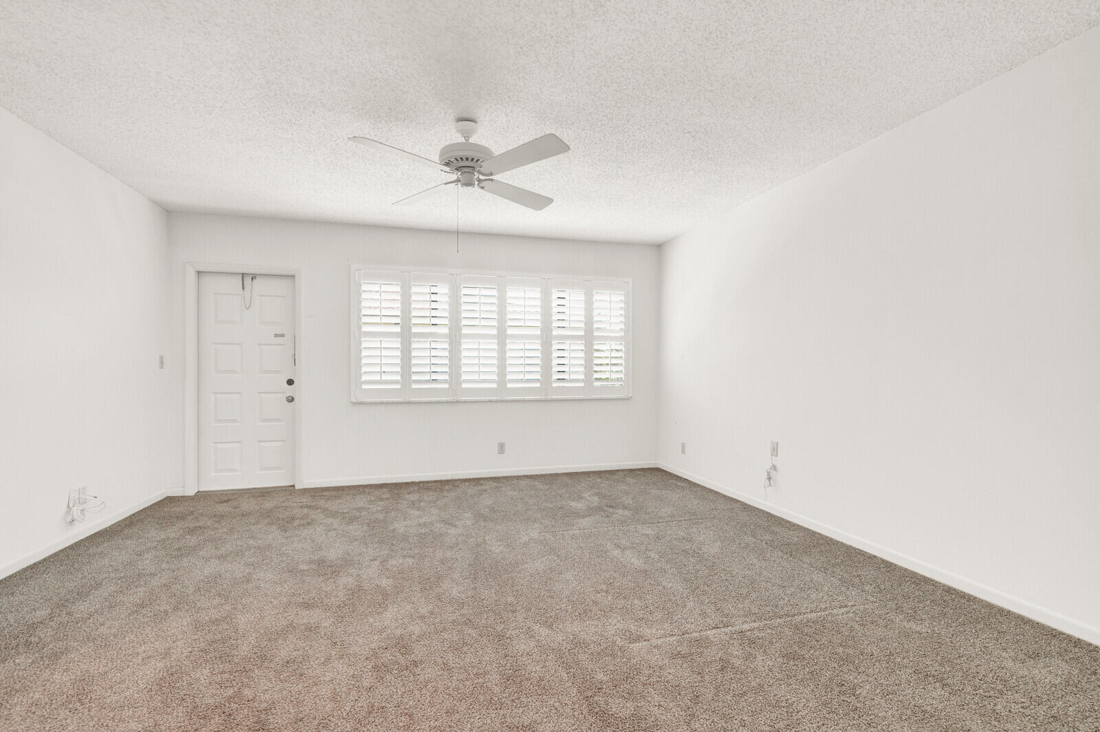 5270 Nesting Way, Unit C Delray Beach, FL 33484 - Photo 21 of 38 an empty room with windows and fan