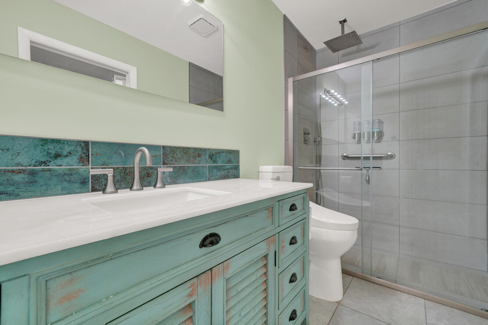5270 Nesting Way, Unit C Delray Beach, FL 33484 - Photo 25 of 38 a view of bathroom with a sink and mirror