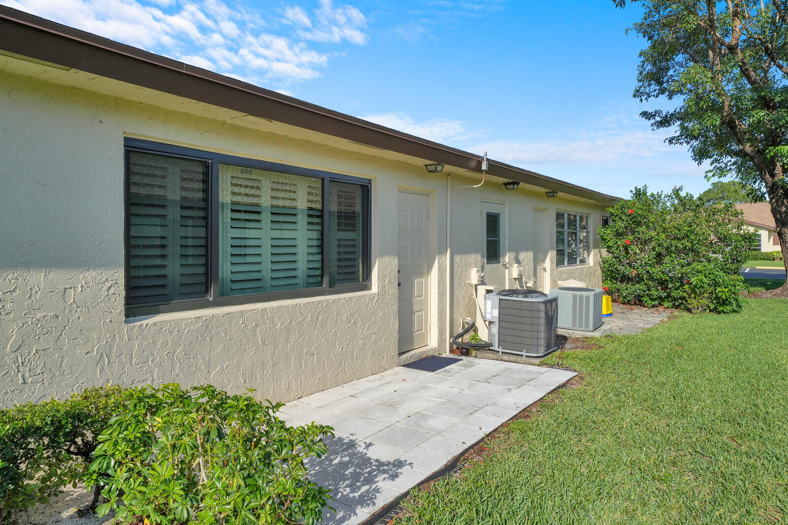 5270 Nesting Way, Unit C Delray Beach, FL 33484 - Photo 29 of 38 a front view of a house with garden