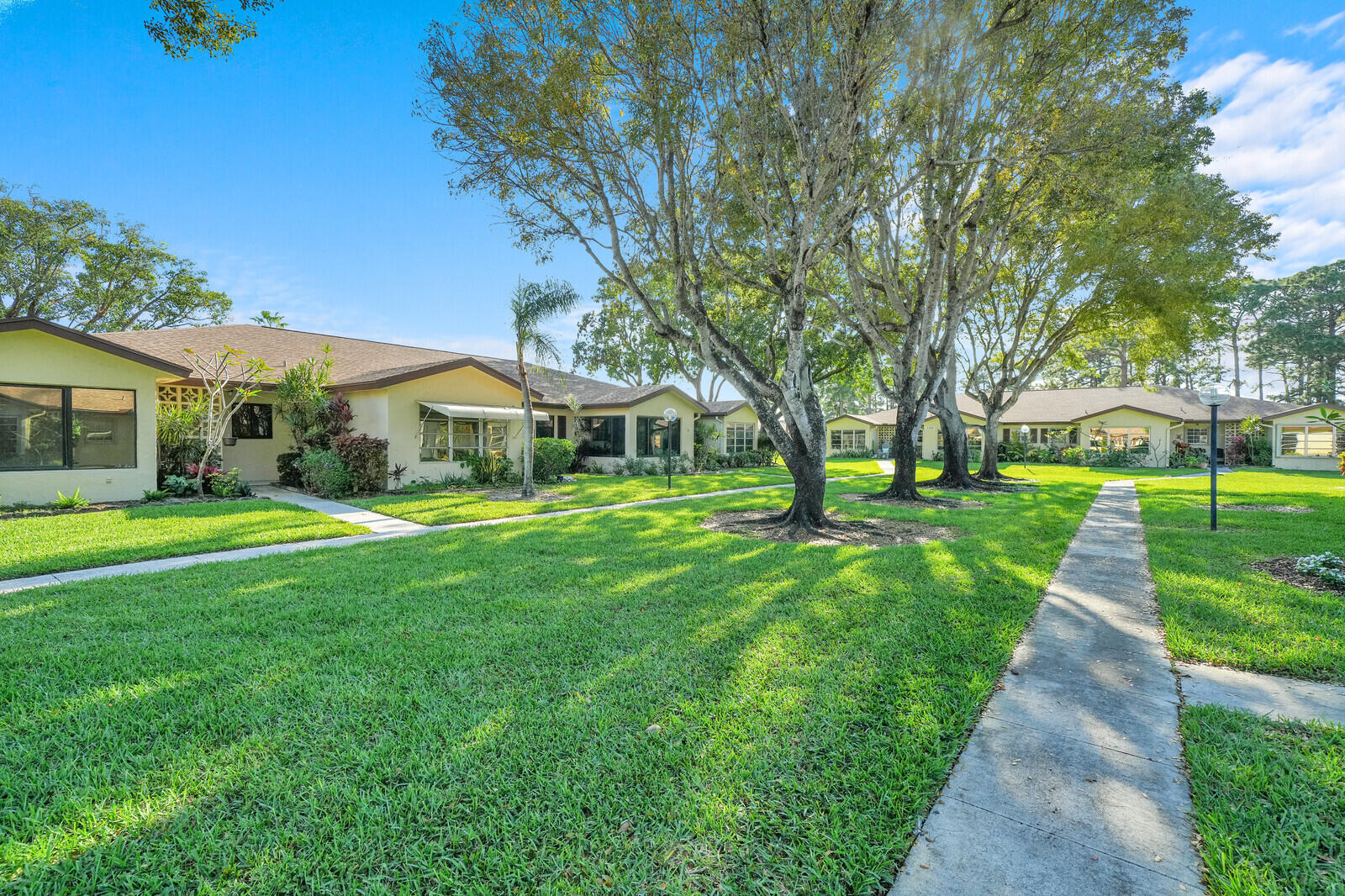 5270 Nesting Way, Unit C Delray Beach, FL 33484 - Photo 3 of 38 a front view of a house with yard and green space