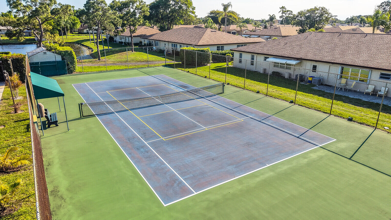 5270 Nesting Way, Unit C Delray Beach, FL 33484 - Photo 38 of 38 an aerial view of a tennis ground with large trees