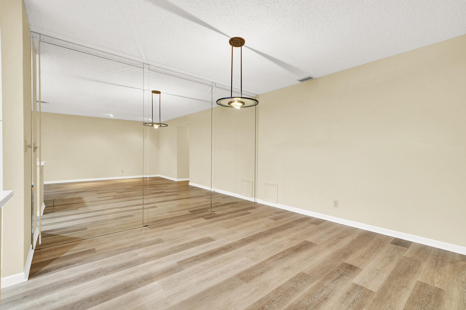 5270 Nesting Way, Unit C Delray Beach, FL 33484 - Photo 8 of 38 an empty room with wooden floor fan and windows