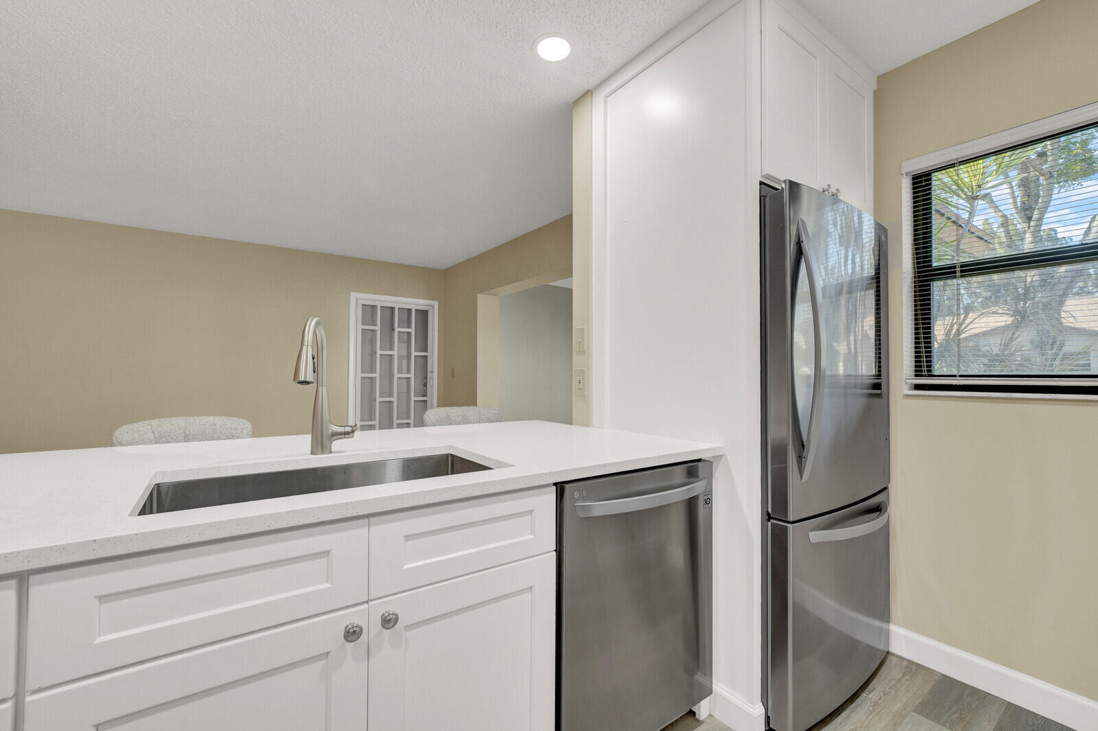 5270 Nesting Way, Unit C Delray Beach, FL 33484 - Photo 10 of 38 a kitchen with stainless steel appliances granite countertop a refrigerator and a sink