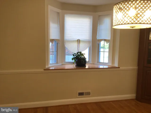 a view of a small space with wooden floor and a window