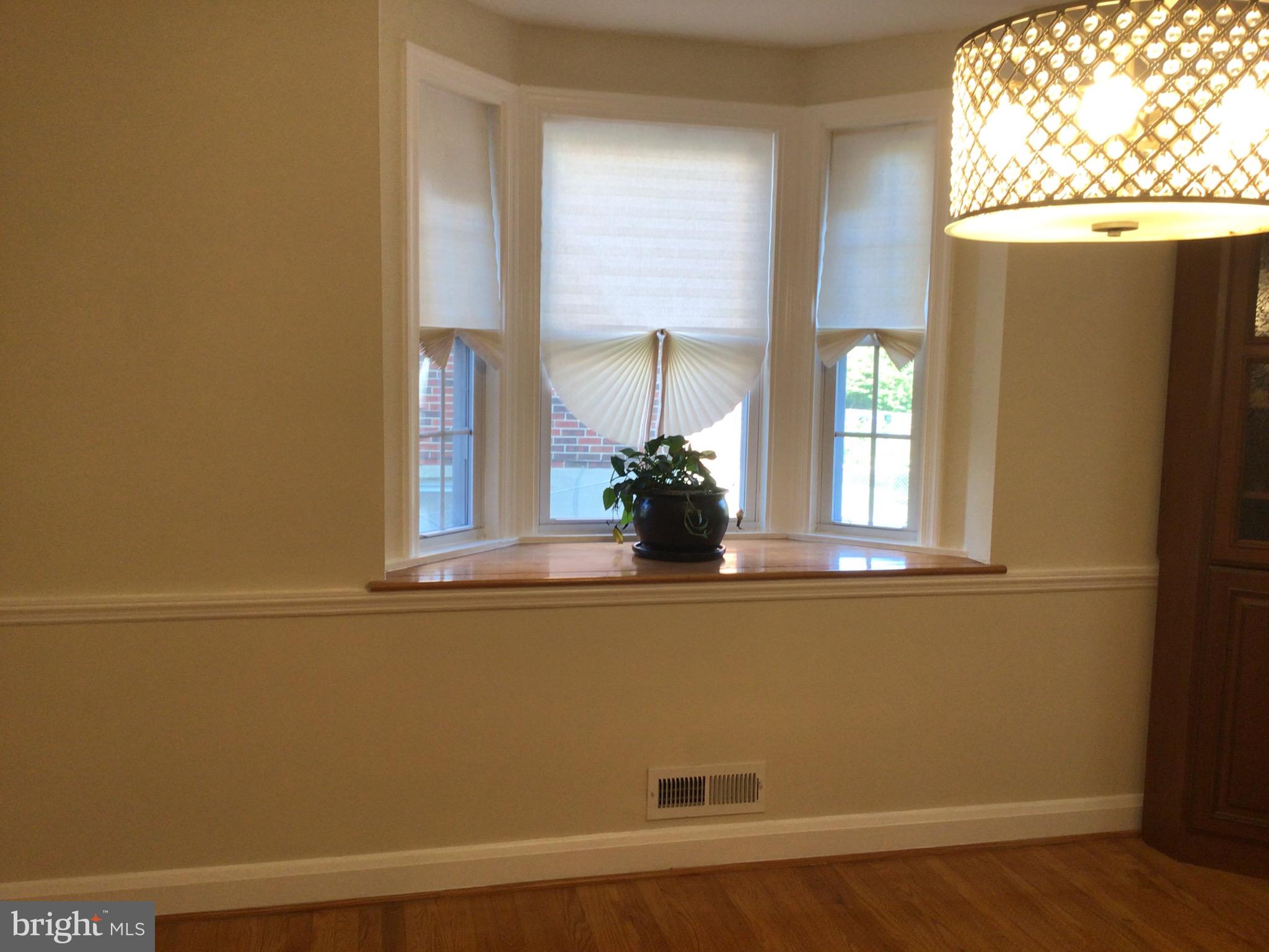1613 Winford Road Baltimore, MD 21239 - Photo 11 of 42 a view of a small space with wooden floor and a window