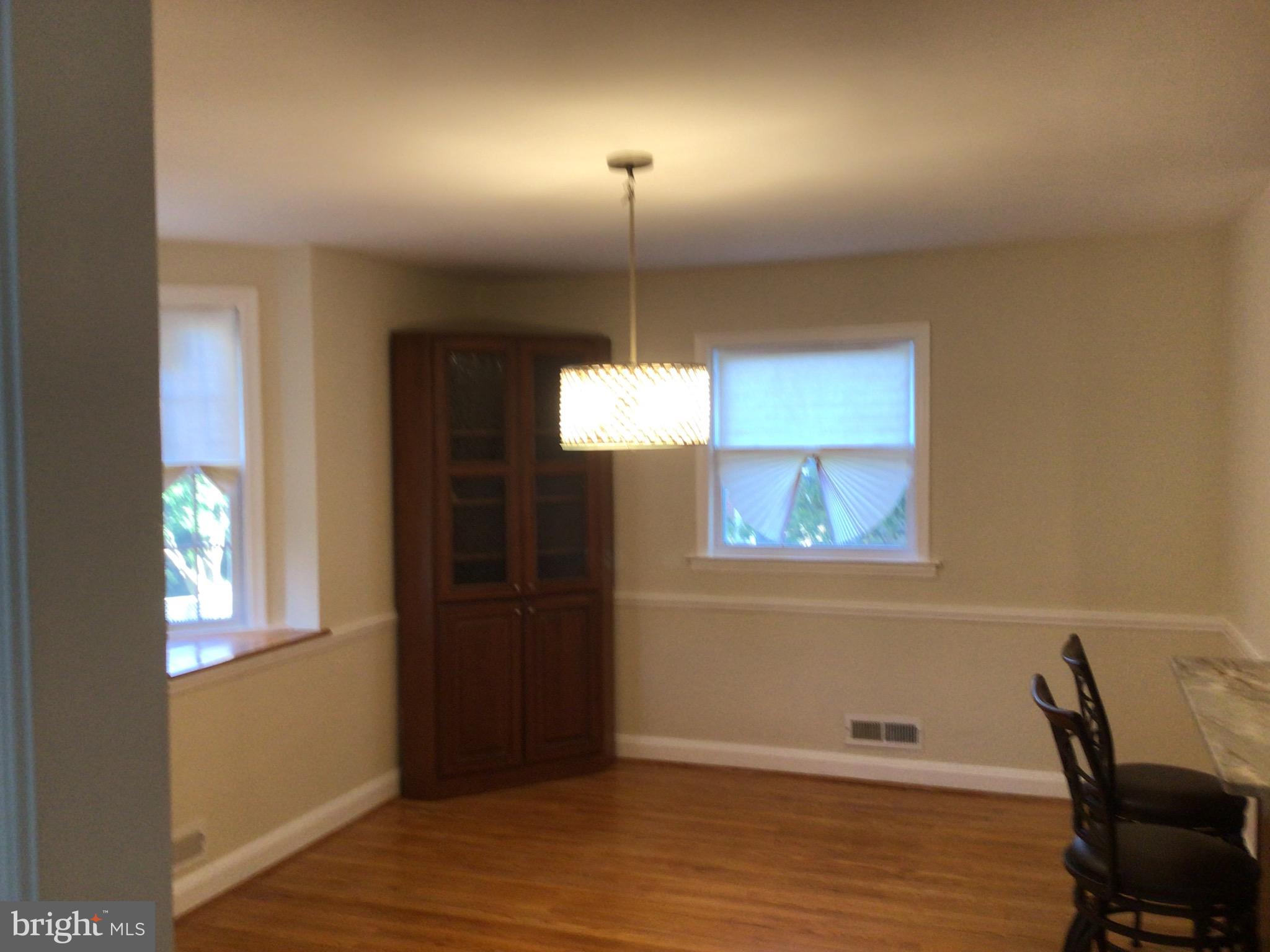 1613 Winford Road Baltimore, MD 21239 - Photo 13 of 42 a view of a room with a window and wooden floor