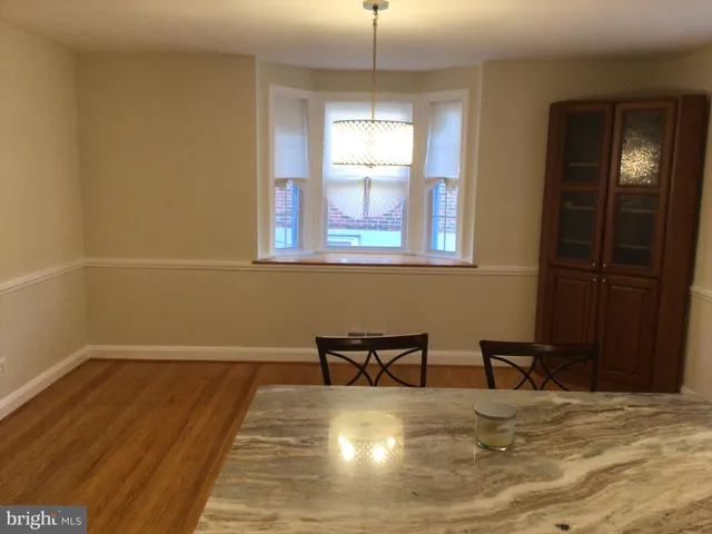 a view of a room with wooden floor and windows