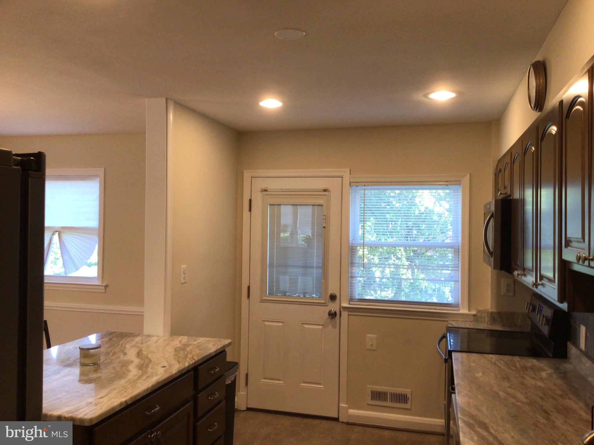 1613 Winford Road Baltimore, MD 21239 - Photo 19 of 42 a view of hallway with granite countertop furniture and a flat screen tv