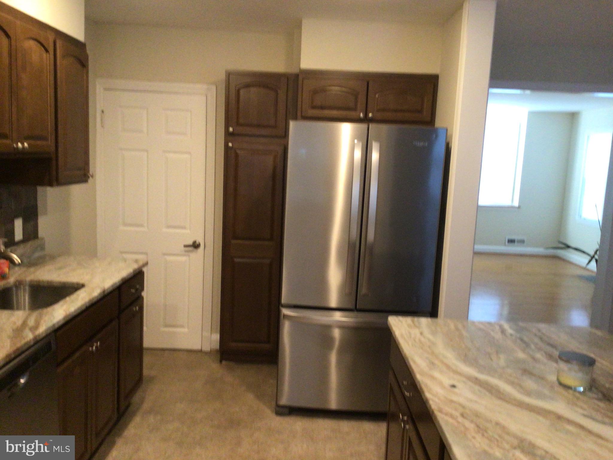 1613 Winford Road Baltimore, MD 21239 - Photo 20 of 42 a kitchen with stainless steel appliances granite countertop a refrigerator and a sink