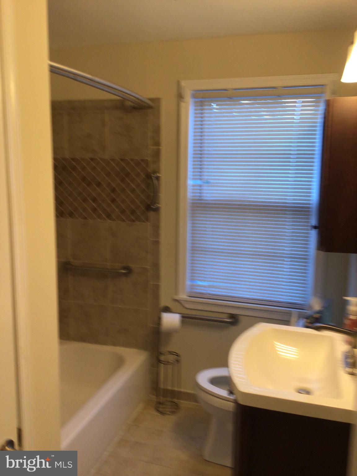 1613 Winford Road Baltimore, MD 21239 - Photo 26 of 42 a bathroom with a bathtub and shower