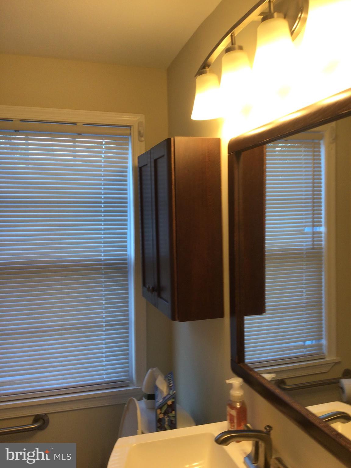 1613 Winford Road Baltimore, MD 21239 - Photo 28 of 42 a bathroom with a sink and a mirror