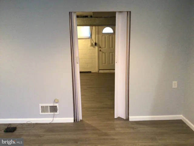 a view of a hallway with wooden floor