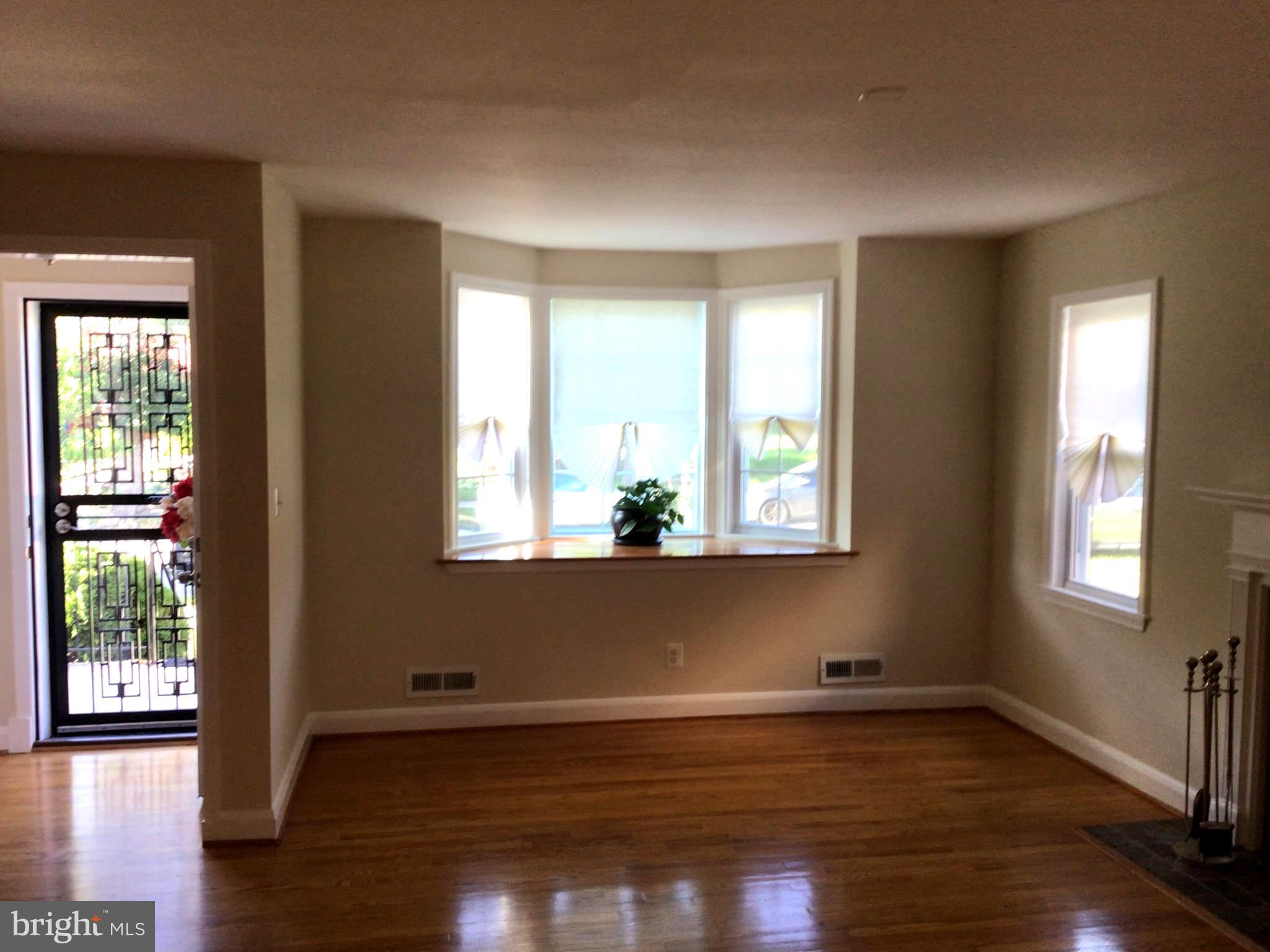 1613 Winford Road Baltimore, MD 21239 - Photo 5 of 42 a view of empty room with wooden floor and fan