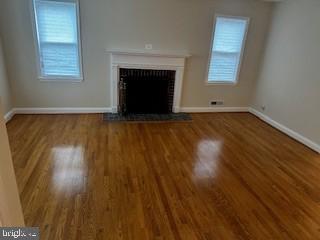 1613 Winford Road Baltimore, MD 21239 - Photo 8 of 42 an empty room with wooden floor and windows