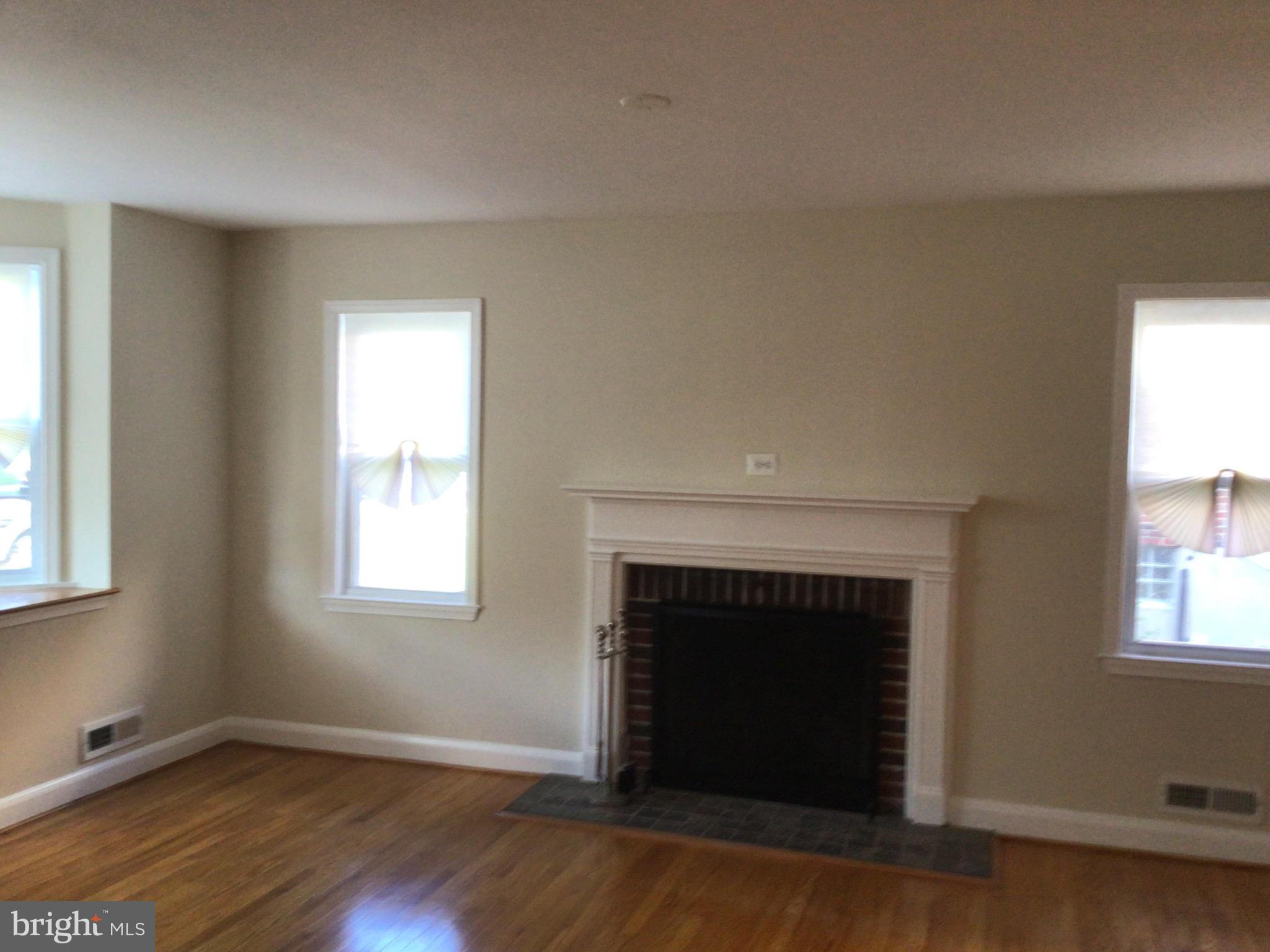1613 Winford Road Baltimore, MD 21239 - Photo 9 of 42 an empty room with windows and fireplace