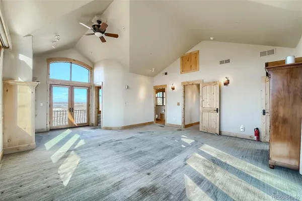 a view of a livingroom with a staircase and a large window