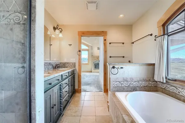 a bathroom with a bathtub and a shower
