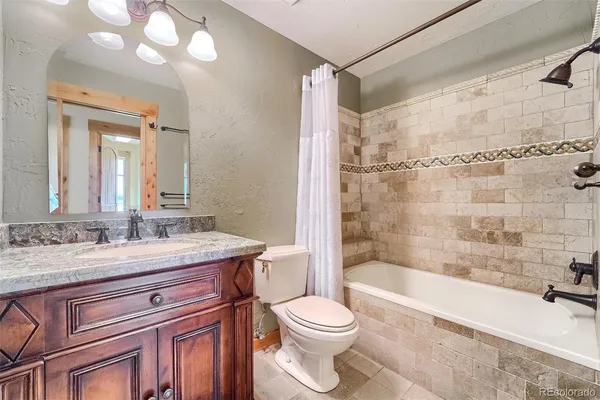a bathroom with a sink toilet vanity and tub